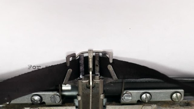 Typing a popular holy bible quote for we walk by faith, not by sight on a vintage typewriter