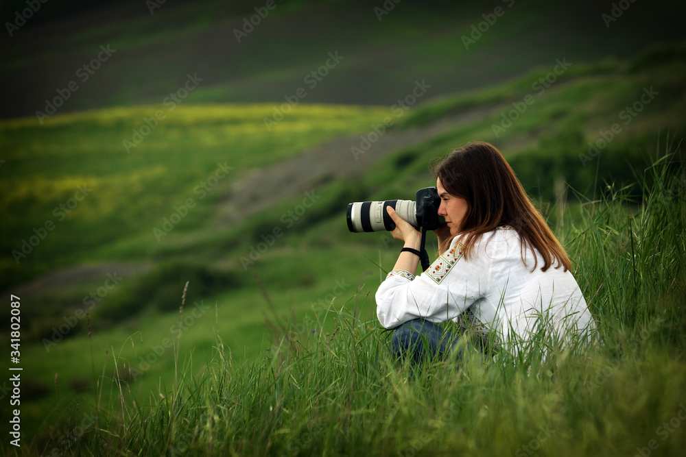 Wall mural young woman landscape photographer in tuscany, italy, europe