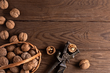 Nuts in a straw woven basket on a wooden table.