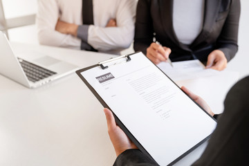Office executives are interviewing job applicants in the meeting room