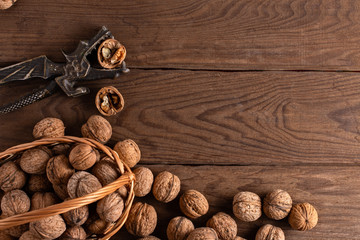 Nuts in a straw woven basket on a wooden table.