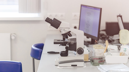 laboratory with modern equipment for blood analysis. The doctor checks the blood of patients. Microscope on the table. Blood test at a modern scientific workplace.