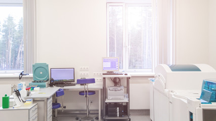 laboratory with modern equipment for blood analysis. The doctor checks the blood of patients. Blood test at a modern scientific workplace.