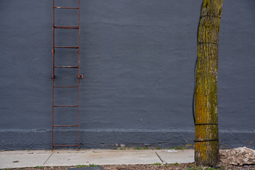 Image of a Dark Grey Wall Background with a ladder 