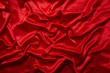 Fototapeta premium Luxury red satin smooth fabric background for celebration, ceremony, event invitation card or advertising poster