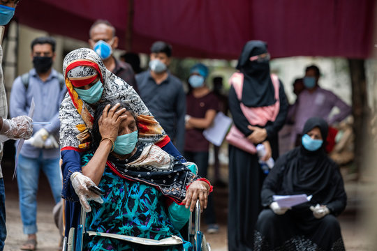 People wait for hours in long queues for Covid-19 tests at BSMMU fever clinic near Shahabagh in the capital of Bangladesh ,Monday morning on April 20,2020. Photo:Saikat Bhadra