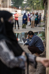 Naklejka premium People wait for hours in long queues for Covid-19 tests at BSMMU fever clinic near Shahabagh in the capital of Bangladesh ,Monday morning on April 20,2020. Photo:Saikat Bhadra