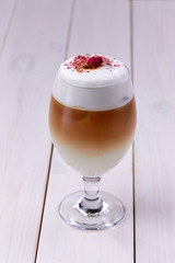 latte with rose on the wooden background