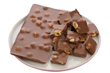 Delicious milk chocolate with hazelnuts on White background