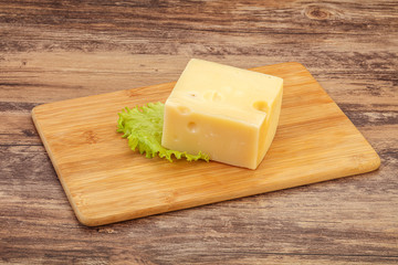 Emmental cheese over wooden board