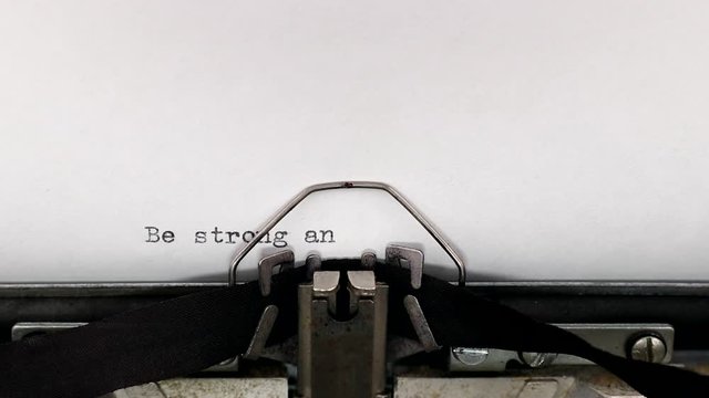 Typing a holy bible quote be strong and take heart, all who hope in the Lord on a vintage typewriter