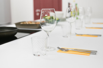 cutlery on a white table. bright kitchen awaiting guests