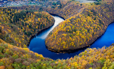 Beautiful Vyhlidka Maj, Lookout Maj, near Teletin, Czech Republic. Meander of the river Vltava surrounded by colorful autumn forest viewed from above. Tourist attraction in Czech landscape. Czechia.