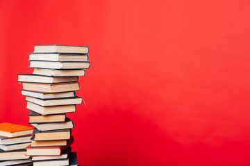 a lot of stacks of educational books in the college library on a red background
