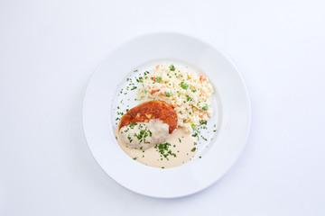 cutlet with rice and vegetables on the white background