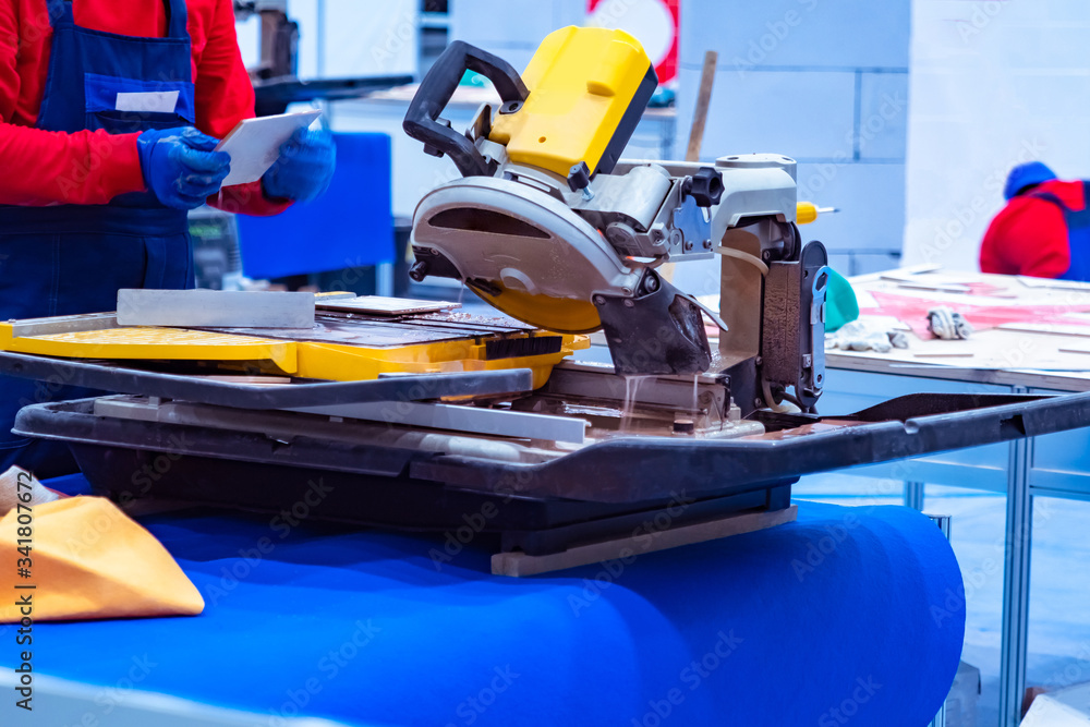 Poster tile processing. stationary circular saw. stone processing workshop. circular saw for tile processin