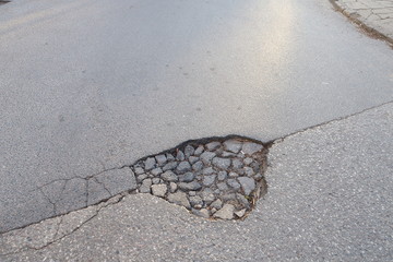 A hole on the asphalt road
