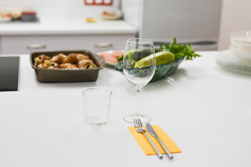 cutlery on a white table. bright kitchen awaiting guests