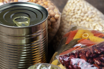 Donations food with canned food on the table background. Donate concept. Close up.
