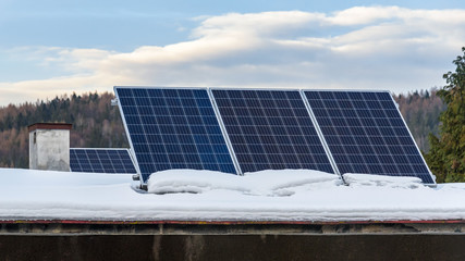 Solar panels on the snow covered roof