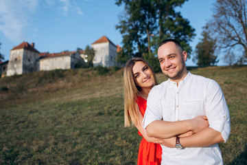 Happy young lovely couple hugging and smiling outside. Handsome man and attractive young woman together