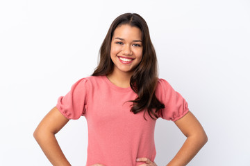 Fototapeta premium Young Colombian girl over isolated white background posing with arms at hip and smiling