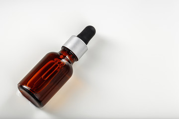 Skincare serum bottle on a light beige background close up