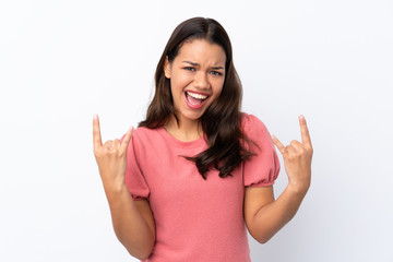 Young Colombian girl over isolated white background making rock gesture