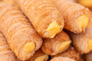 Puff pastries sweet cream tubes. Bakery products, closeup
