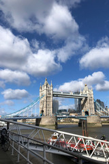 Fototapeta na wymiar Tower Bridge with the blue sky and clouds on a bright sunny day in spring, London, UK