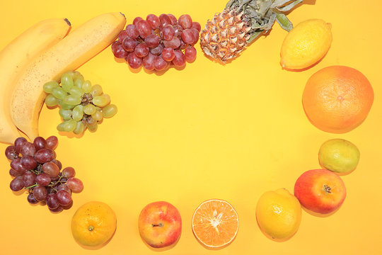 Summer banner, citrus fruits, grapefruit, orange, lemon, bananas on a yellow background, minimal diet concept, healthy and natural food, flat lay, home delivery service.