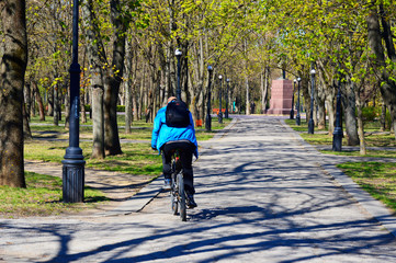 man rides a bicycle in a spring park. active lifestyle