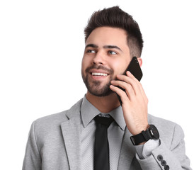 Young businessman talking on smartphone against white background