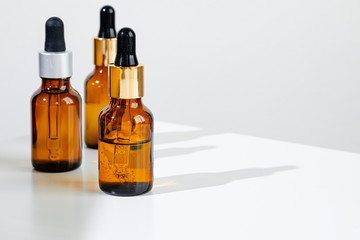 Oily skincare moistrizing brown glass jar with pipette close up