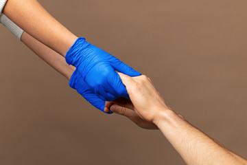 Handshake in a blue gloves, help concept.