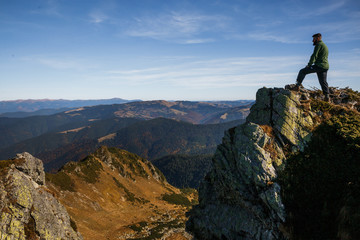 Man standing on the cliff in mountains