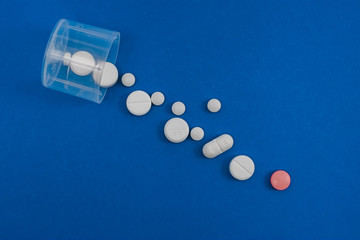 Scattered pills on a blue background.
