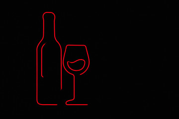Retro neon sign with the bottle and glass. Vintage electric symbol. Burning a pointer to a black wall in a club, bar or cafe. Design element for ad, signs, posters, banners