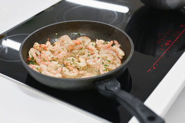 fried shrimp in a pan. cook on electric stove