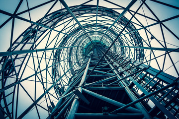 Steel structure of the observation tower in Batumi. Iron pipes create a futuristic image of the structure. Web of metal. View from the bottom up. Day Cloudy.