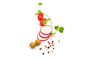 Sliced radish with cherry tomatoes and olives, isolated on white background