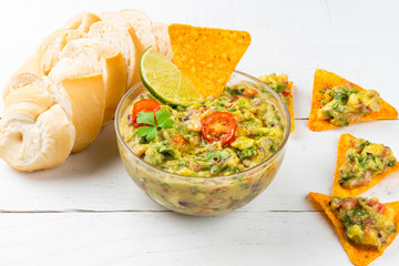 Bowl of guacamole with tortilla chips. Avocado Mexican food.