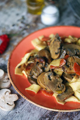 Plate of pasta with mushrooms, cream and spices. The recipe for pasta with mushrooms. Cooking at home.
