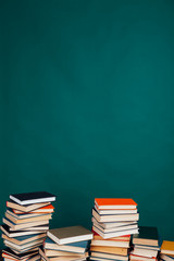 many stacks of educational books in the university library on a green background