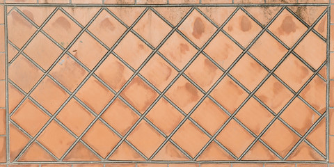 Stone fence. Fence made of bricks, stone, tiles. The structure of brick, stone.