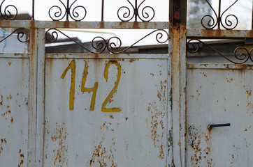 Iron fence. Iron old door. Old paint on the door, the fence.