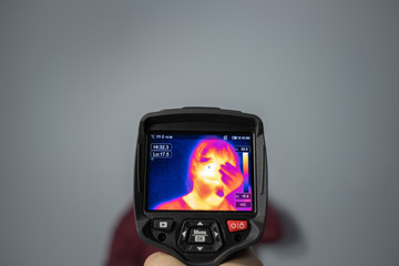 Thermal camera vision of woman who holding her forehead, Coronavirus high fever control, Covid-19 protection concept