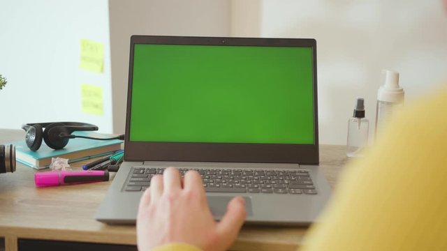 Hands young man typing on laptop with green screen work from home internet computer online business display people network digital monitor slow motion