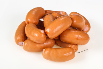 Tasty meat sausages over white background