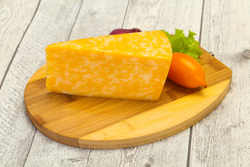 Marble cheese  triangle over wooden